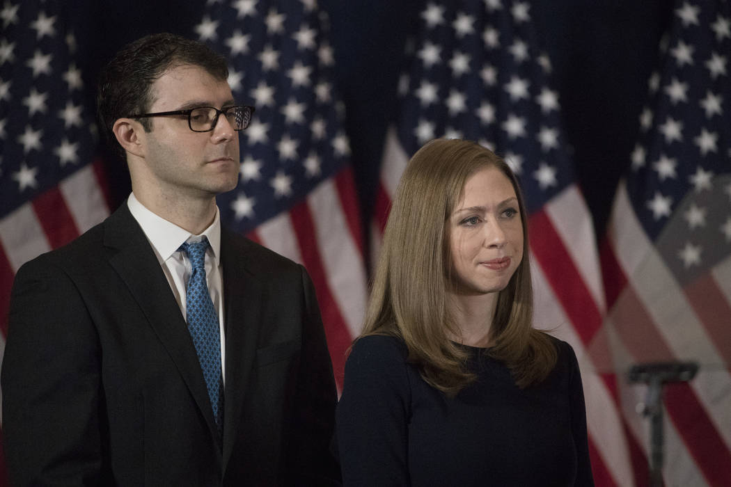 FILE - In this Nov. 9, 2016 file photo Chelsea Clinton and her husband Marc Mezvinsky listen to ...