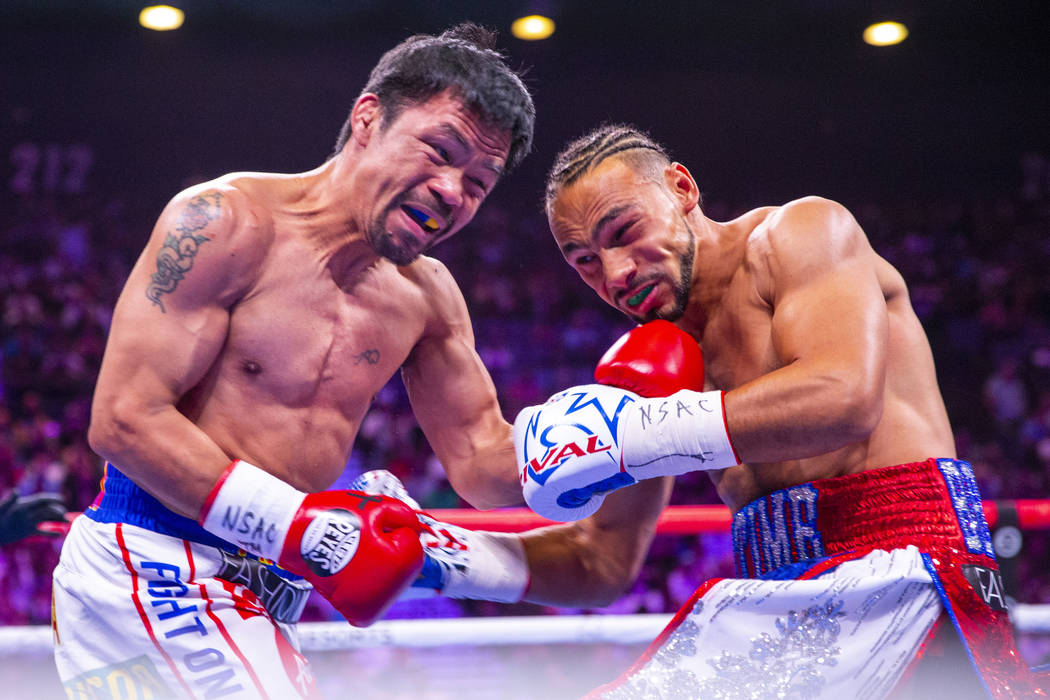 Manny Pacquiao punches Keith Thurman during Round 1 of their WBA super welterweight world champ ...
