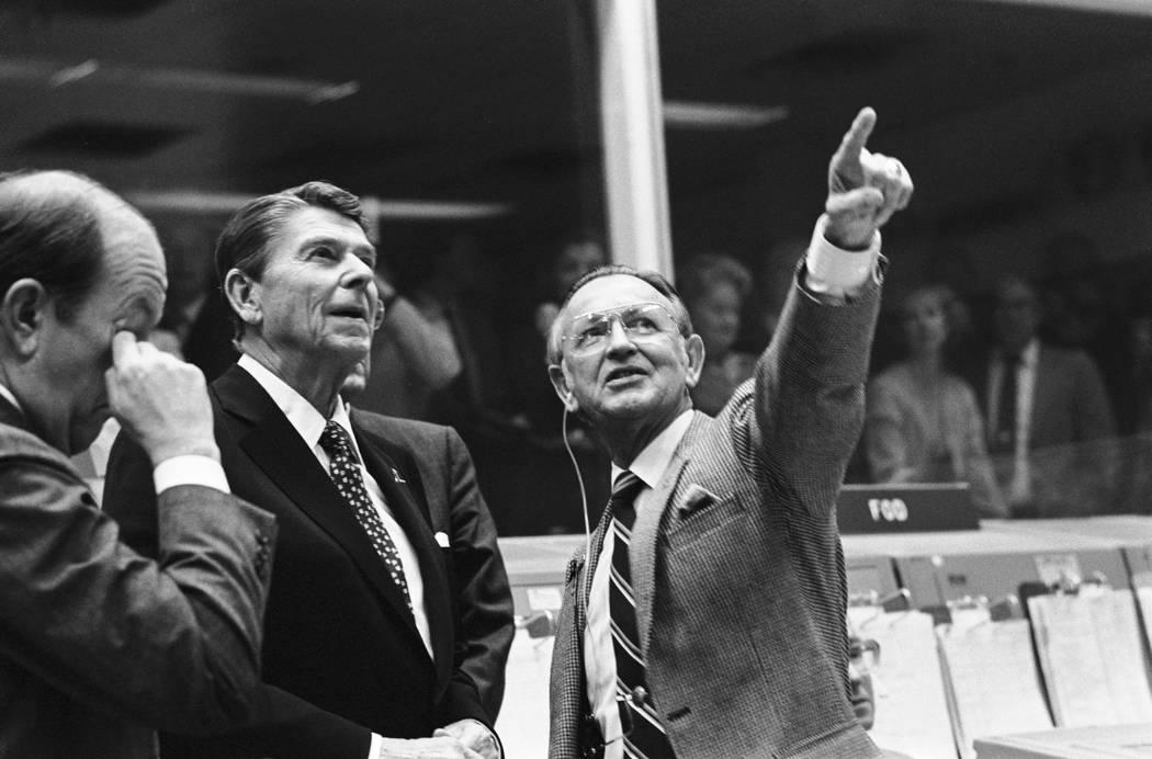 In this Nov. 13, 1981, photo provided by NASA, President Ronald Reagan is briefed by Johnson Sp ...