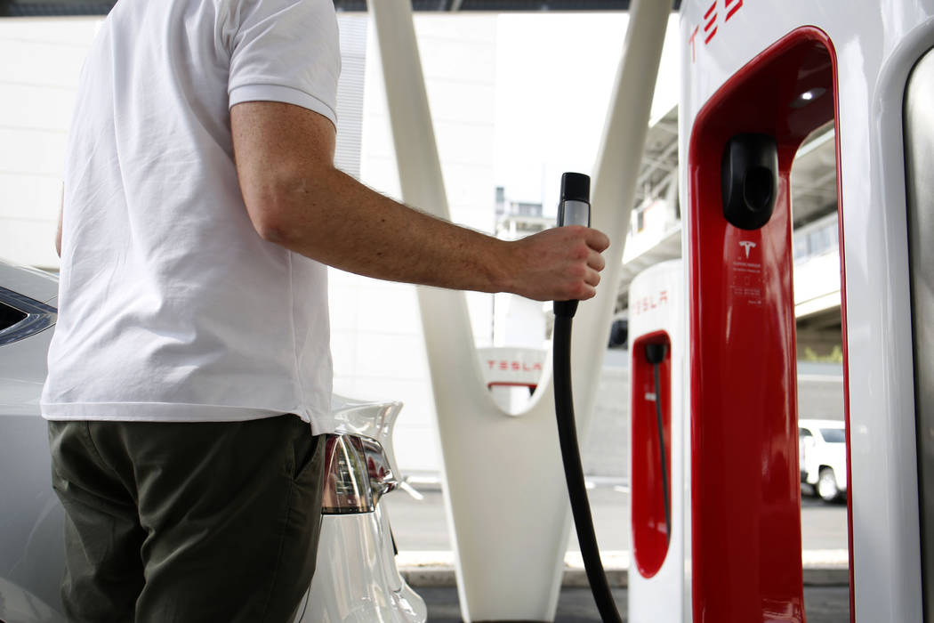 Tesla's Model X is charged at the largest Tesla Supercharger station now open near the High Rol ...