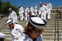 FILE - In this June 27, 2019, file photo, incoming plebes carry their belongings down a stairca ...