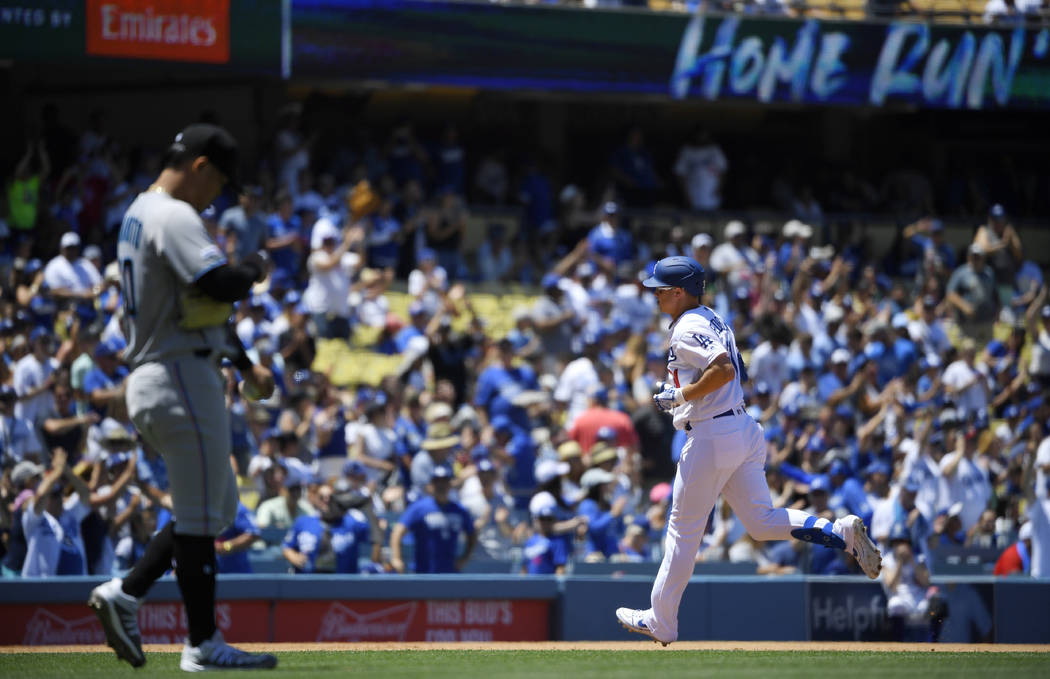 Los Angeles Dodgers' Joc Pederson, right, rounds third after hitting a two-run home run as Miam ...