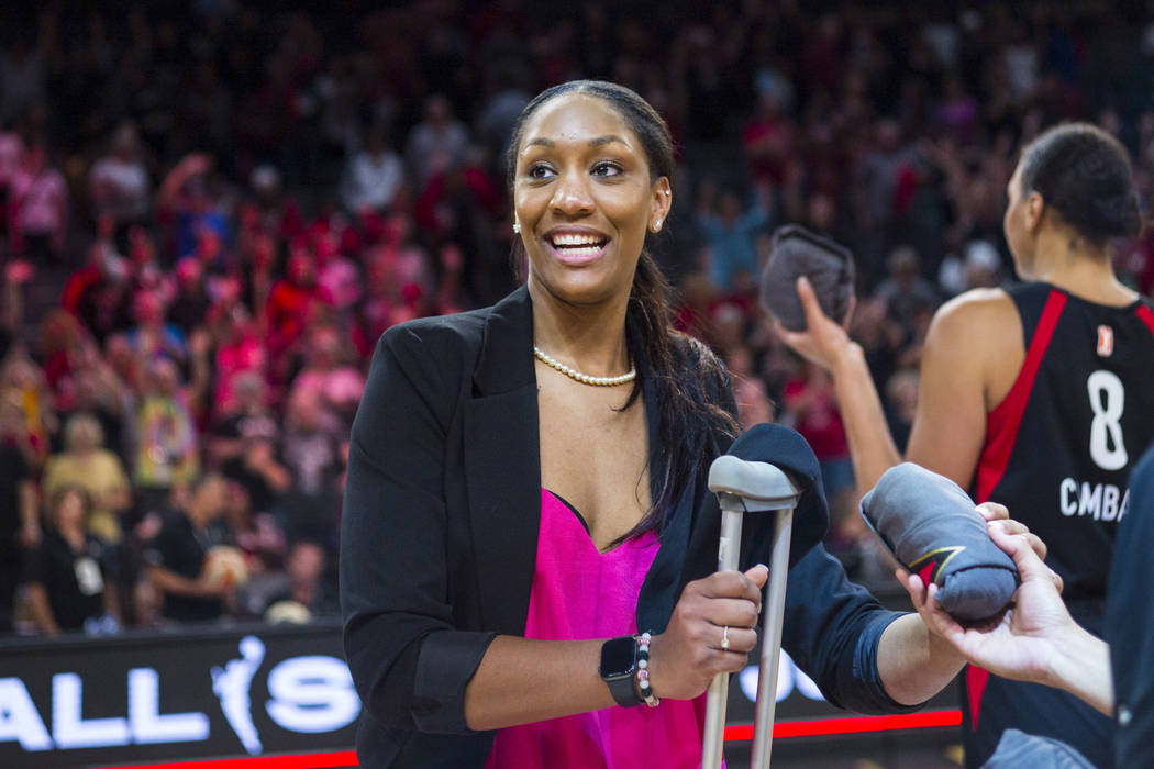 Las Vegas Aces' A'ja Wilson looks to throw t-shirts to the crowd after a WNBA basketball game a ...
