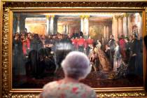 Britain's Queen Elizabeth II looks at a painting of Queen Victoria inspecting wounded Coldstrea ...