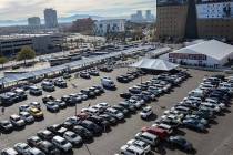 Rows of cars fill surrounding parking lots as crowds of people gather for the opening day of th ...