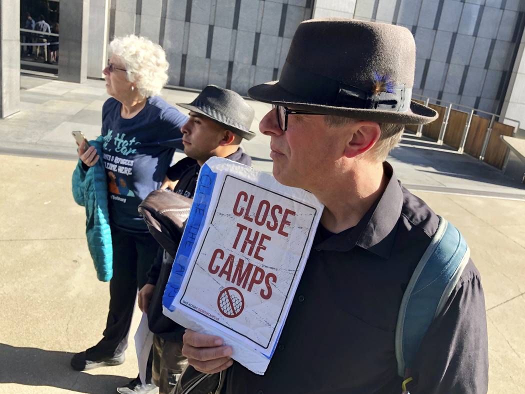 Ben Terrall holds a protest sign that reads "Close The Camps" outside of the San Fran ...