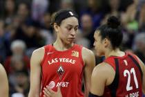 Las Vegas Aces' Dearica Hamby, left, talks with Kayla McBride (21) during a break against the S ...