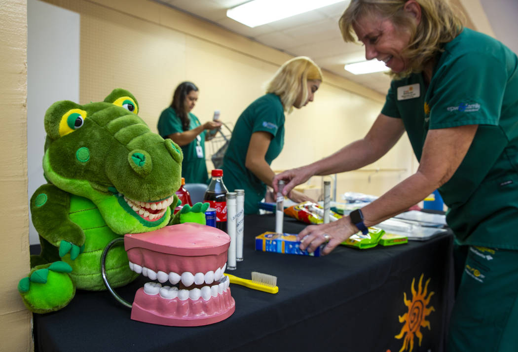 Elizabeth Metz, from right, Stephanie Martinez and Xochi Flores with Future Smiles set up a den ...
