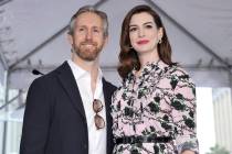 FILE - This May 9, 2019 file photo shows actress Anne Hathaway, right, and her husband Adam Shu ...