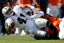 Oakland Raiders running back Keith Smith (41) is tackled by Denver Broncos linebacker Brandon M ...