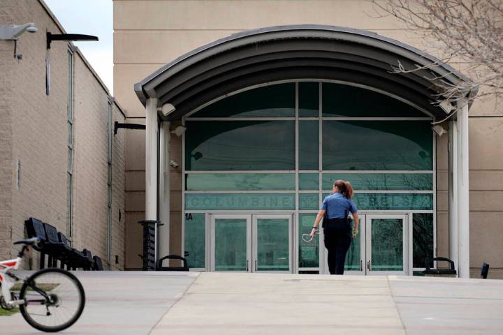 FIE - In this April 17, 2019, file photo, a police officer walks to the front doors of Columbin ...