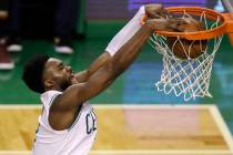 Boston Celtics guard Jaylen Brown dunks against the Cleveland Cavaliers during the second half ...