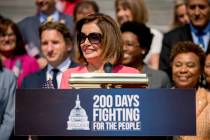 House Speaker Nancy Pelosi of Calif. and House Democrats smiles as she speaks at a news confere ...