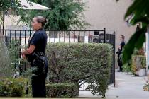 Los Angeles police officers guard an apartment where a shooting occurred in the Canoga Park are ...