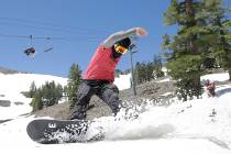 FILE - In this July 1, 2017 file photo, a snowboarder cuts throughout the snow at the Squaw Val ...