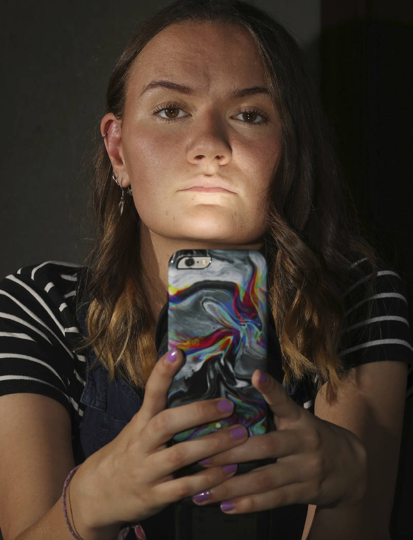 In this Monday, July 22, 2019, photo, Rachel Whalen poses with her phone at her home in Draper, ...