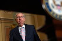 Senate Majority Leader Mitch McConnell of Ky., arrives to speak with reporters following the we ...