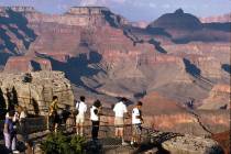 Visitors view the Grand Canyon from Mather Point on the South Rim at Grand Canyon National Park ...