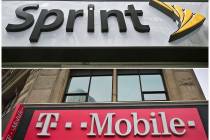 A combination of April 30, 2018, file photos shows signage for a Sprint store in New York's Her ...