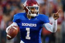 Oklahoma quarterback Jalen Hurts gestures during the NCAA college football team's spring game i ...