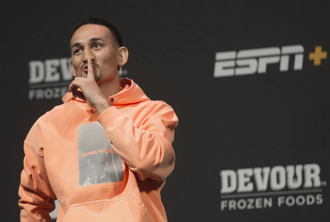 UFC featherweight champion Max Holloway jokes around with the crowd during a press conference o ...