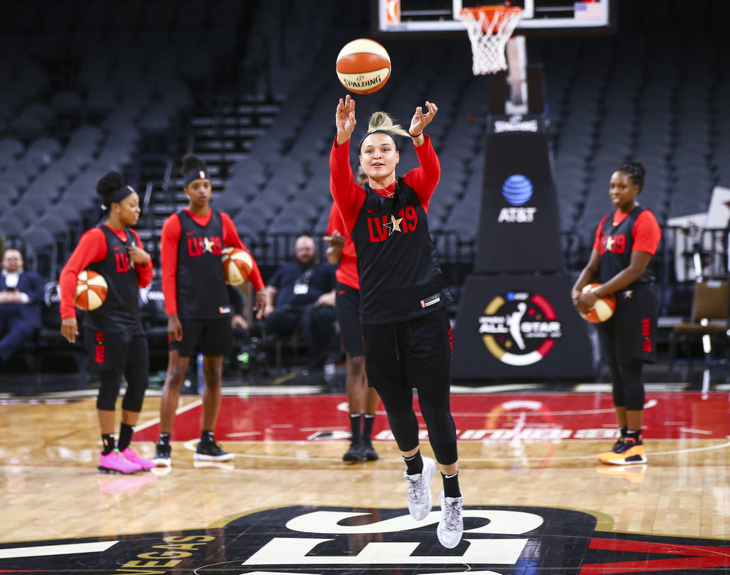 Las Vegas Aces' Kayla McBride attempts a half-court shot during practice ahead of the WNBA All- ...