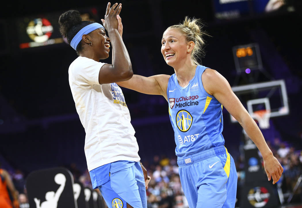 Chicago Sky's Courtney Vandersloot, right, celebrates with teammates Diamond DeShields after co ...