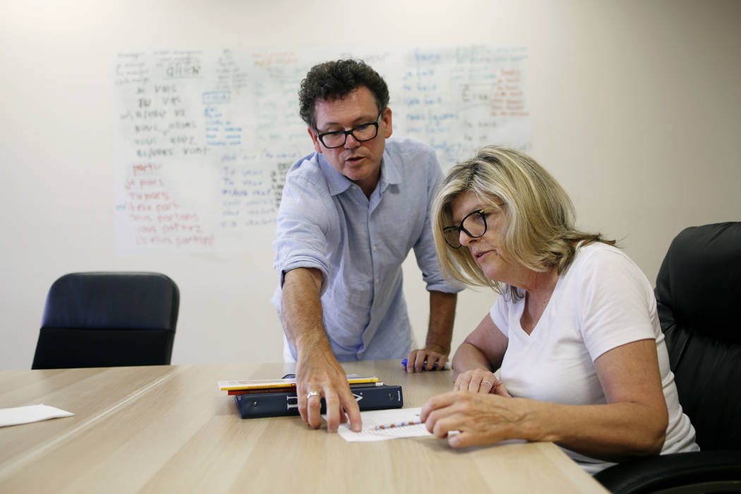 Instructor Lionel Huddlestone, left, and Donna Yoast participates in a French lesson at the All ...