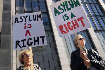 Protestors hold signs that read " Asylum is a Right" outside of the San Francisco Federal Court ...