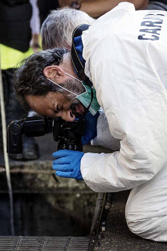 In this picture taken Friday, July 26, 2019 investigators are seen on the scene where an Italia ...