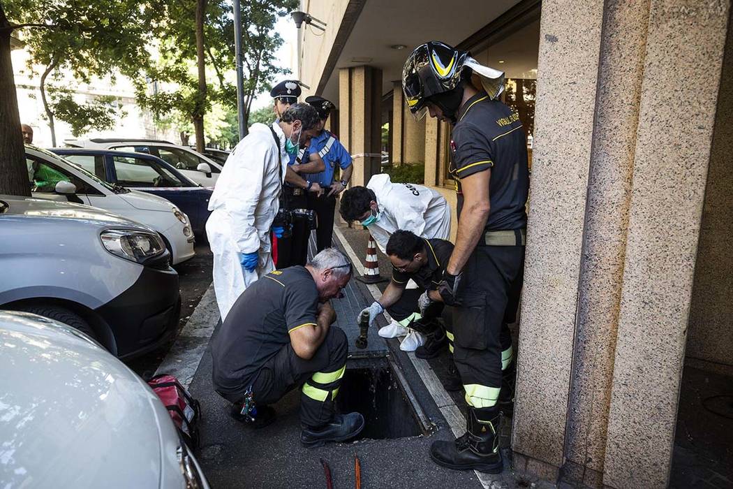 In this picture taken Friday, July 26, 2019 investigators are seen on the scene where an Italia ...