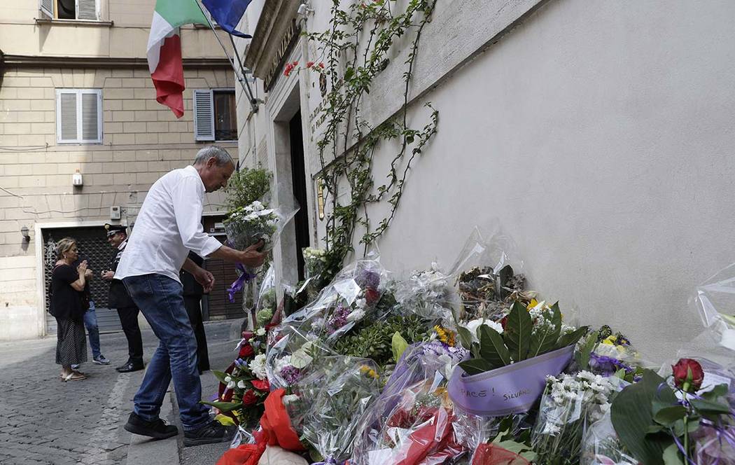 A man leaves flowers in front of the Carabinieri station where Mario Cerciello Rega was based, ...