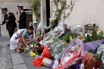 A woman leaves flowers in front of the Carabinieri station where Mario Cerciello Rega was based ...