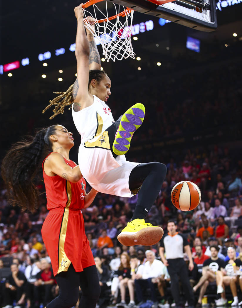 Phoenix Mercury's Brittney Griner dunks in front of Las Vegas Aces' Liz Cambage during the firs ...