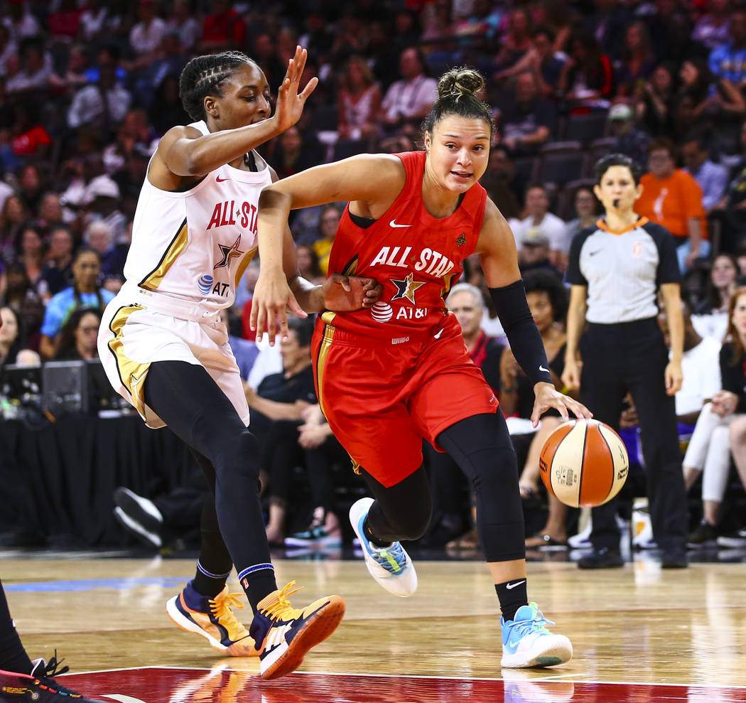 Las Vegas Aces' guard Kayla McBride drives to the basket against Los Angeles Sparks' Nneka Ogwu ...