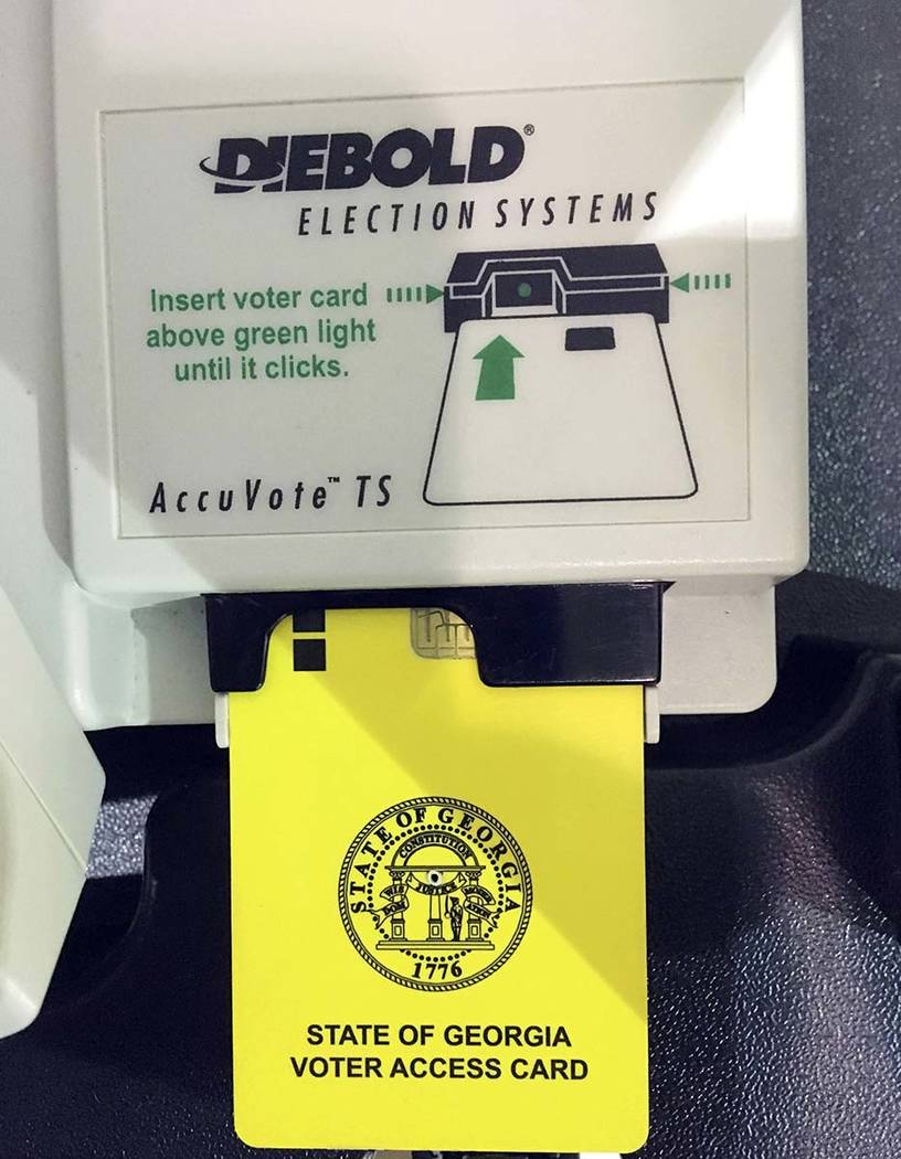 This May 22, 2018, file photo, shows a voter access card inserted in a reader during voting in ...