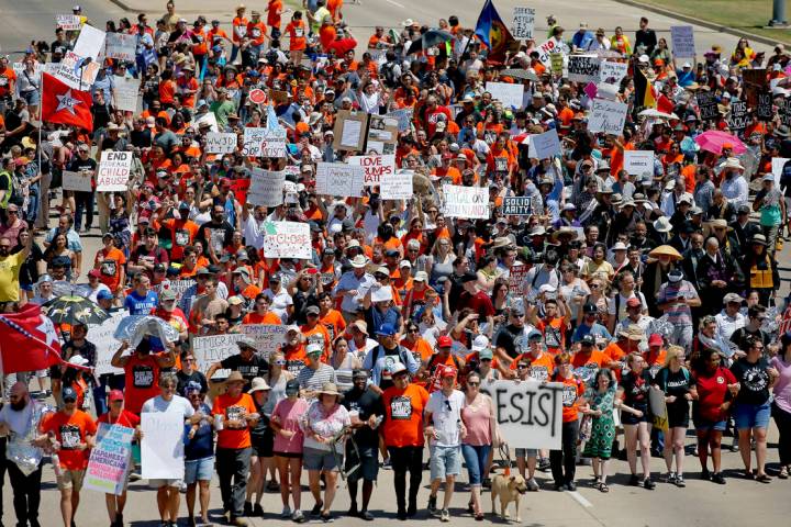 In this July 20, 2019 file photo, protestors march outside Fort Sill in protest of plans to pla ...