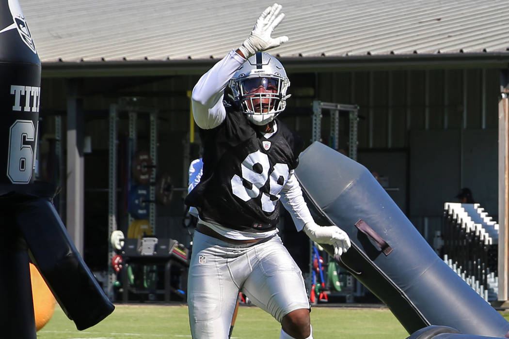 Oakland Raiders defensive end Arden Key (99) hits tackle posts during the NFL team's training c ...