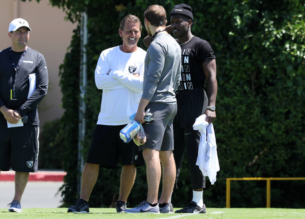 Oakland Raiders wide receiver Antonio Brown (84), right, meets with offensive coordinator Greg ...