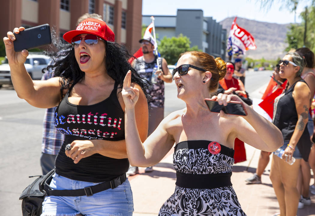 Counter protester Jennifer Harrison, left, with the AZ Patriots group, live-streams as Tamara T ...