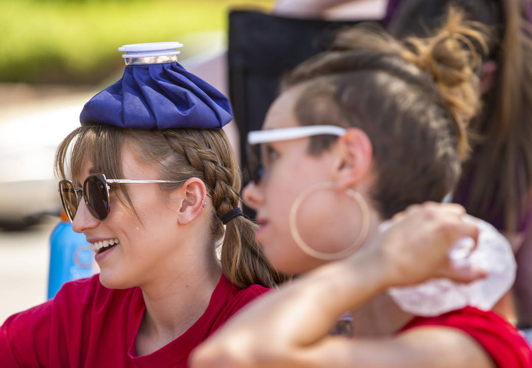 Protesters Taylor Abell, left, and Rachel Siota attempt to stay cool at the Red Rage Protest fo ...