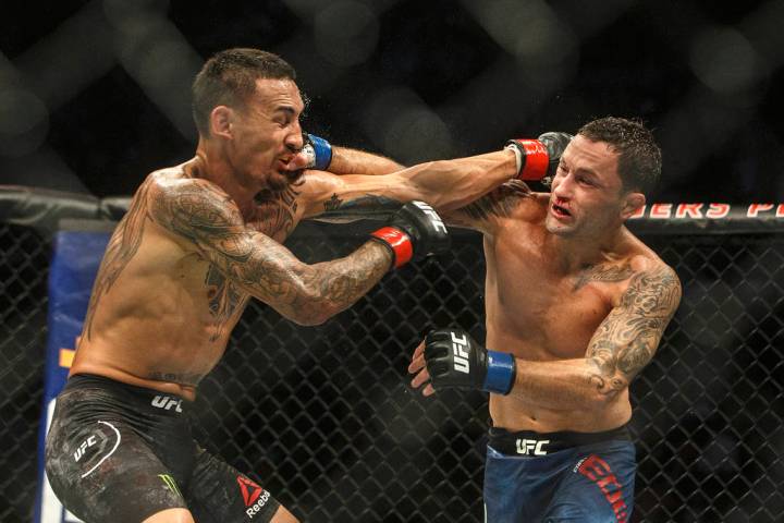 Max Holloway, left, and Frankie Edgar connect on each other during a mixed martial arts bout a ...