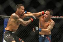 Max Holloway, left, and Frankie Edgar connect on each other during a mixed martial arts bout a ...