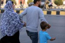 Afghan family flee from near the site of a deadly attack in Kabul, Afghanistan, Sunday, July 28 ...