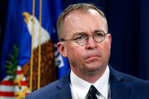 FILE- In this July 11, 2018, file photo Mick Mulvaney, listens during a news conference at the ...
