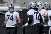 Oakland Raiders offensive tackle Kolton Miller (74) runs toward his fellow offensive linemen du ...