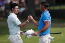 Rory McIlroy, of Northern Ireland, left, shakes hands Brooks Koepka after Koepka won the final ...