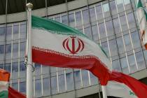 The Iranian flag waves outside of the UN building that hosts the International Atomic Energy Ag ...