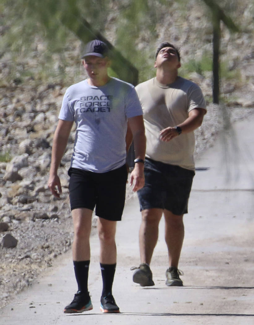Two men walk at Cornerstone Park during a hot morning on Monday, July 29, 2019, in Henderson. ( ...
