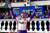 Denny Hamlin celebrates in Victory Lane after winning a NASCAR Cup Series auto race, Sunday, Ju ...